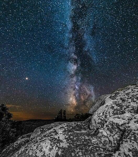 Milky Way sky with boulder in foreground